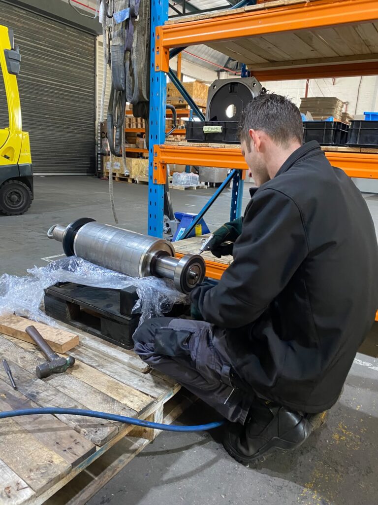 Technician fitting bearings to the servo motor rotor