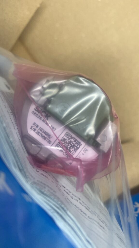 Replacement encoder in protective packaging for the Allen-Bradley servo motor